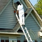 Painter Working at Roofline